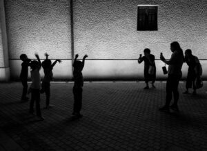 grayscale photo of people standing near wall
