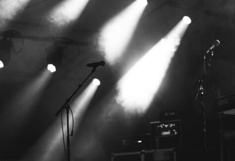 a black and white photo of a stage with lights